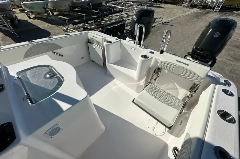 Slide: The Image of 2026 Twin Vee 280 GFX2 CC boat interior with seating and dual engines. - 16