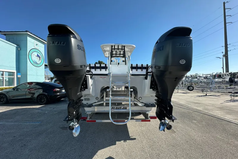 Slide: The Image of 2026 Twin Vee 280 GFX2 CC boat with dual Suzuki 300 engines, parked outdoors. - 4