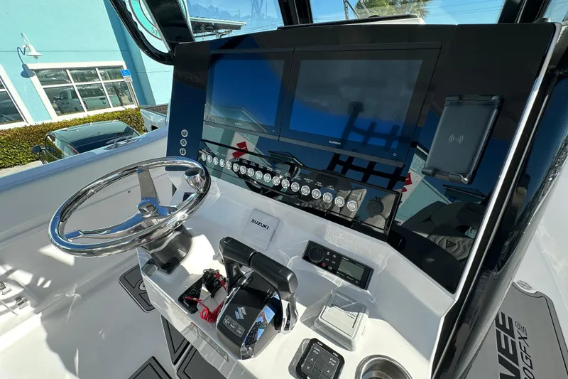 Slide: The Image of 2026 Twin Vee 280 GFX2 CC boat dashboard with modern controls and navigation screens. - 6