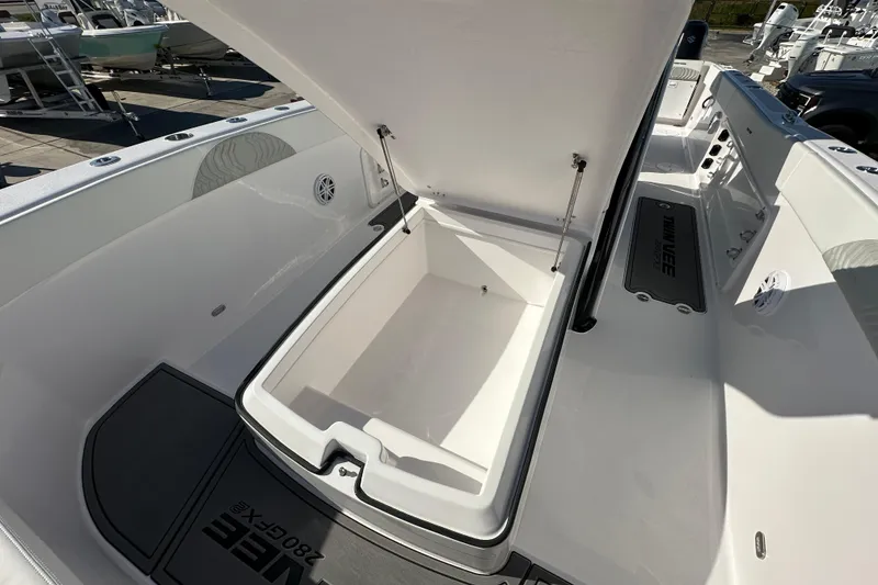 Slide: The Image of 2026 Twin Vee 280 GFX2 CC boat with open storage compartment on deck. - 9