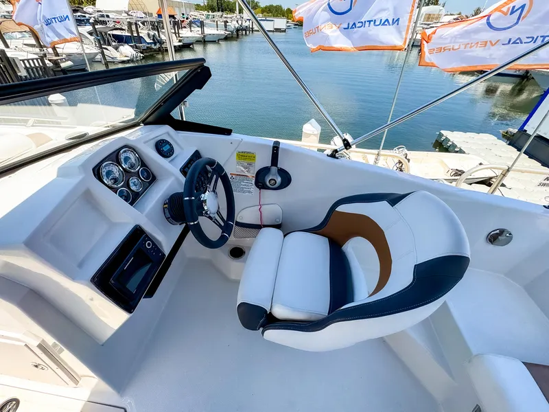 Slide: The Image of 2023 Starcraft SVX 190 OB boat cockpit with steering wheel and comfortable seating. - 8
