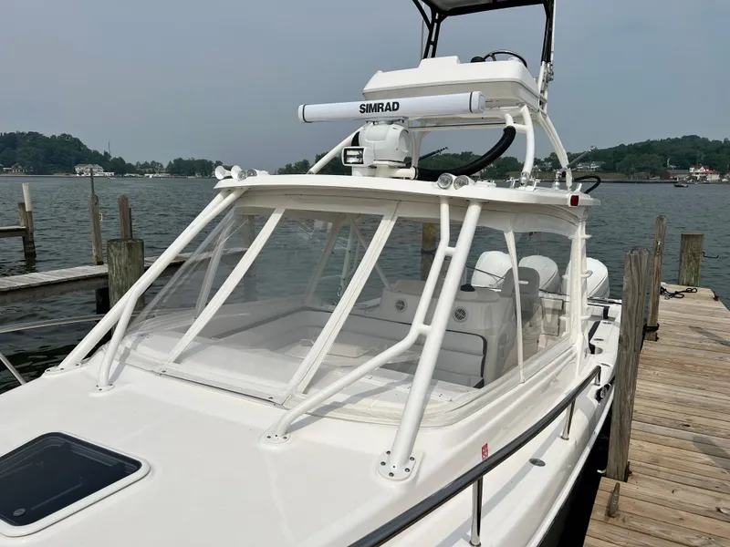 Slide: The Image of 2012 Everglades 350LX boat docked, featuring Simrad equipment and sleek design. - 12