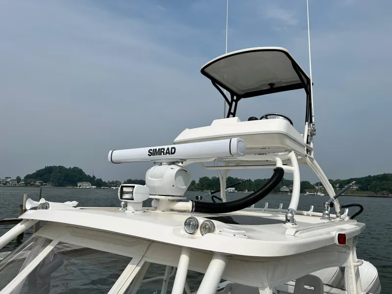 Slide: The Image of 2012 Everglades 350LX boat with Simrad radar, on calm water, under a clear sky. - 13