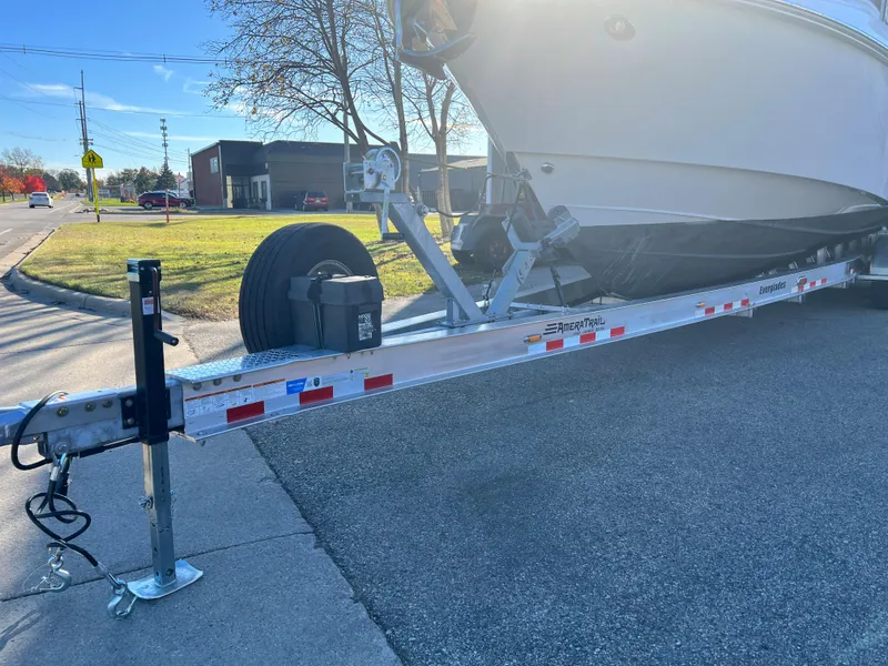 Slide: The Image of 2012 Everglades 350LX boat on a trailer, parked on a sunny street. - 14