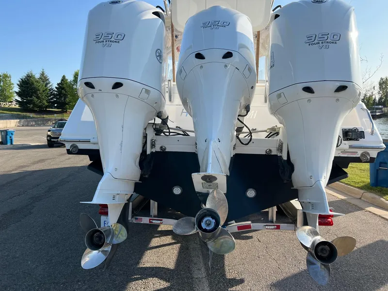Slide: The Image of Triple outboard motors on a 2012 Everglades 350LX boat, parked on a sunny day. - 18