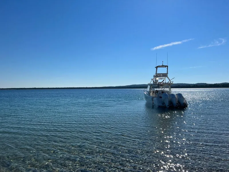 Slide: The Image of Everglades 350LX boat on clear blue water under sunny sky, 2012 model. - 2