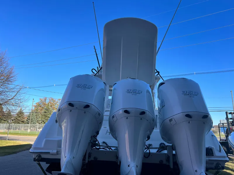 Slide: The Image of 2012 Everglades 350LX boat with triple outboard engines, viewed from the rear. - 23