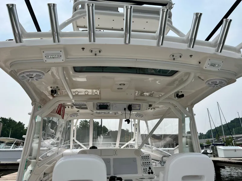 Slide: The Image of 2012 Everglades 350LX boat interior with rod holders and navigation equipment. - 25