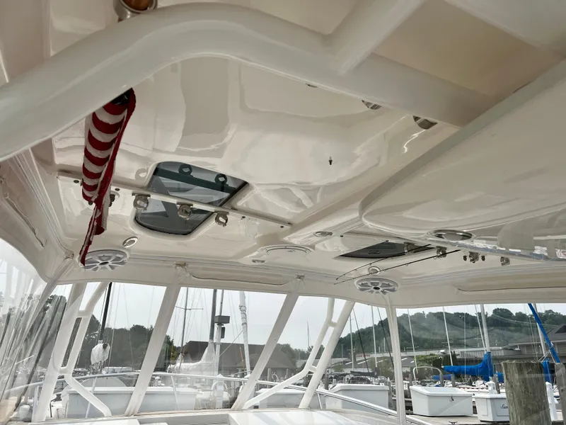Slide: The Image of Interior view of 2012 Everglades 350LX boat with overhead features and docked sailboats. - 28