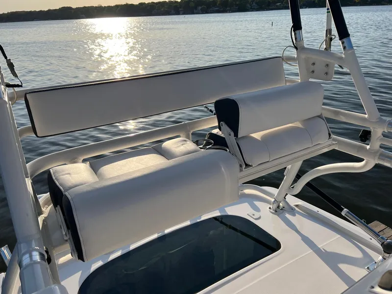 Slide: The Image of 2012 Everglades 350LX boat seating with sunset over water. - 30