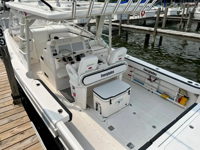 Slide: The Image of 2012 Everglades 350LX boat docked, featuring spacious deck and modern controls. - 31