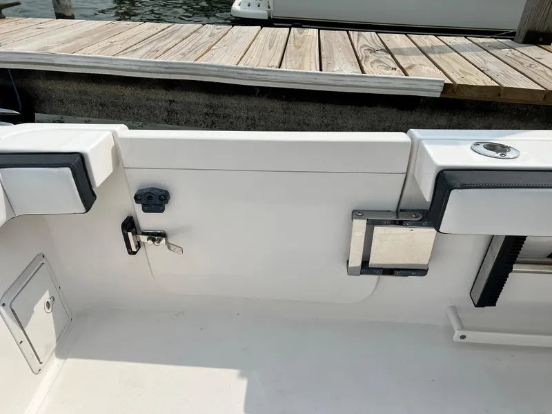 Slide: The Image of Interior view of a 2012 Everglades 350LX boat near a wooden dock. - 34