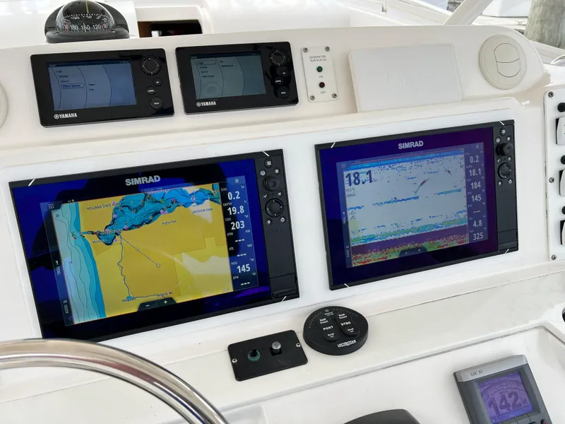 Slide: The Image of Boat dashboard with Simrad navigation displays on a 2012 Everglades 350LX. - 36