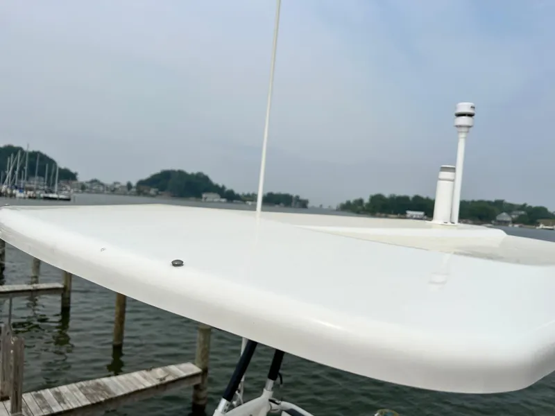 Slide: The Image of 2012 Everglades 350LX boat detail with radar, docked by a serene waterfront. - 41