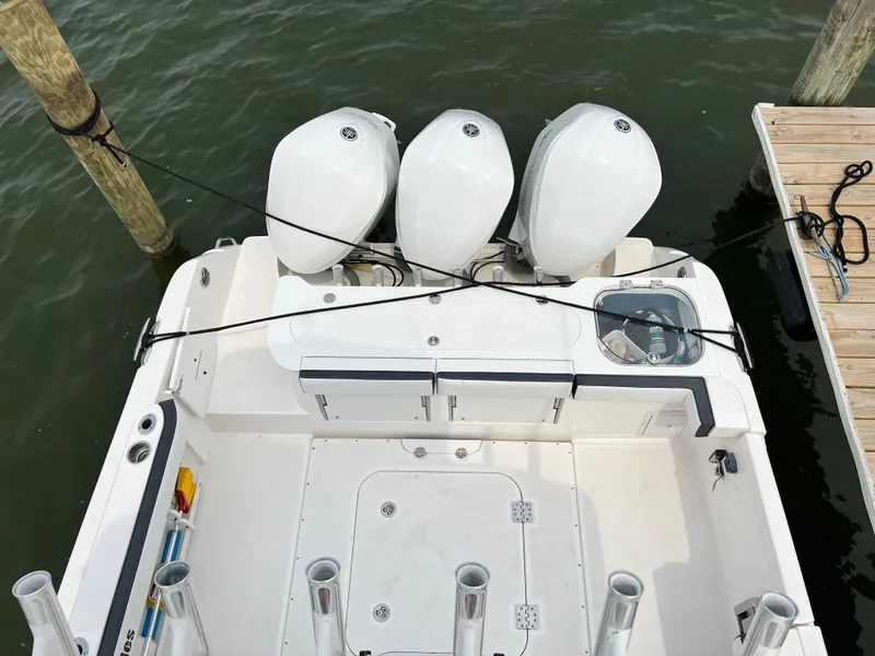 Slide: The Image of 2012 Everglades 350LX boat with triple outboard engines docked at marina. - 42