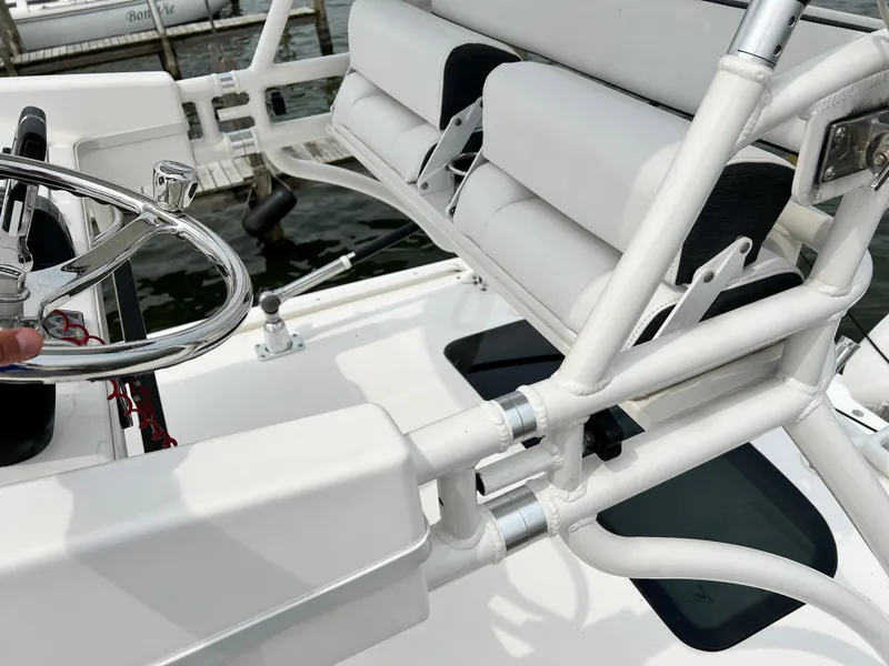 Slide: The Image of Interior view of a 2012 Everglades 350LX boat, featuring steering wheel and seating. - 48
