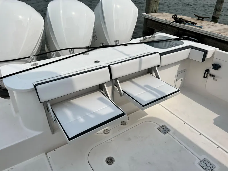 Slide: The Image of 2012 Everglades 350LX boat with foldable seating and triple outboard engines. - 49