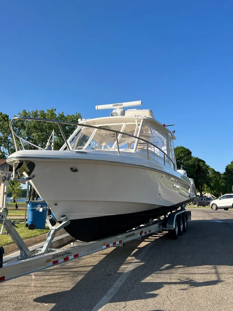 Slide: The Image of 2012 Everglades 350LX boat on trailer under clear blue sky. - 7