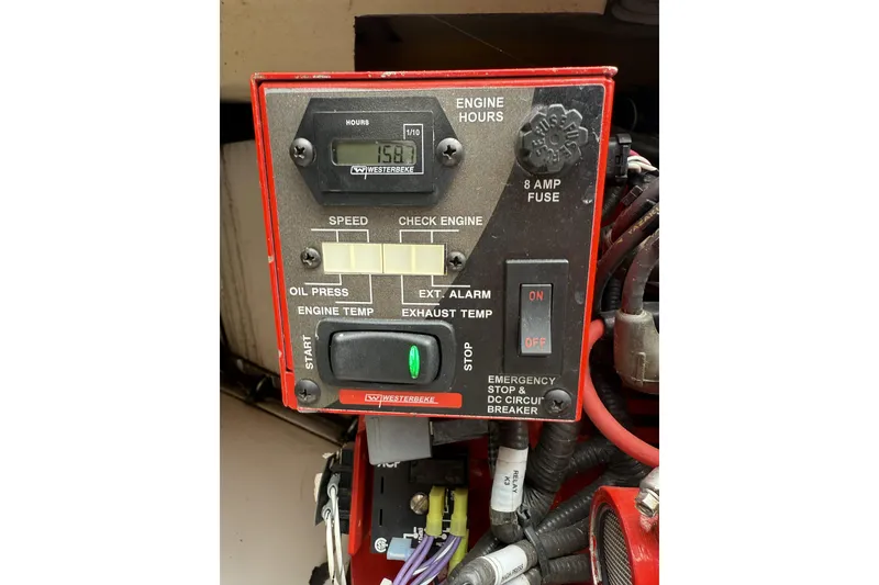 Slide: The Image of Control panel of a 2012 Everglades 350LX boat, featuring engine hours and emergency stop. - 82