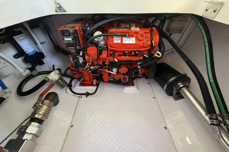 Slide: The Image of Engine compartment of a 2012 Everglades 350LX boat, featuring a vibrant red engine. - 85