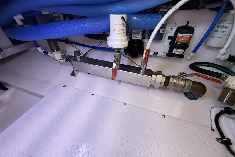 Slide: The Image of Engine room of 2012 Everglades 350LX boat with plumbing and filtration system. - 87