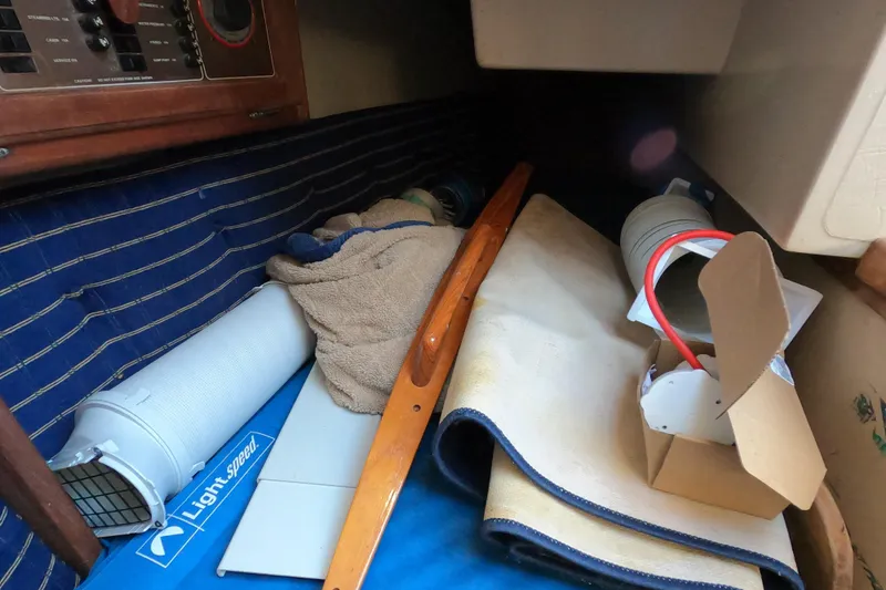 Slide: The Image of Interior of a 1986 Catalina 27 sailboat with various stored items. - 10