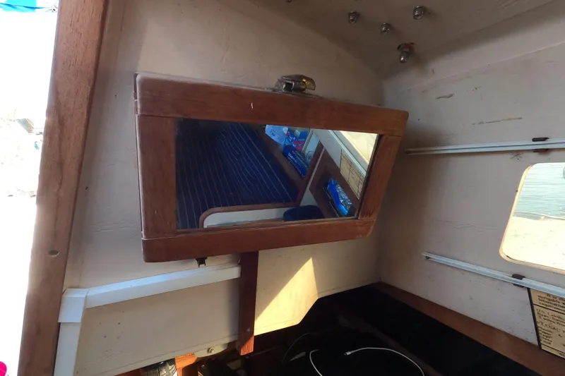 Slide: The Image of Interior of a 1986 Catalina 27 sailboat with a wooden-framed mirror. - 15