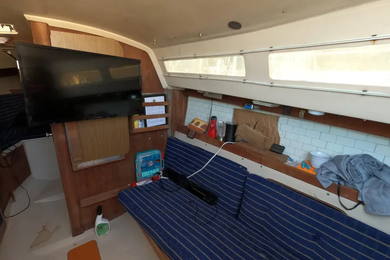 Slide: The Image of Interior of 1986 Catalina 27 sailboat with TV, seating, and nautical decor. - 5