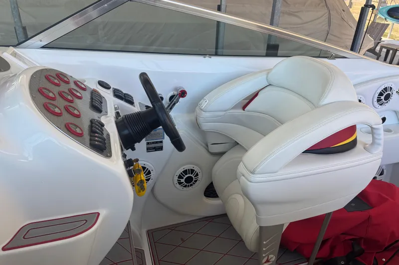 Slide: The Image of 2005 Baja 342 boat cockpit with white leather seating and control panel. - 10