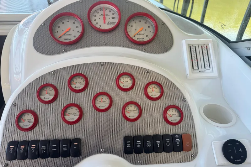 Slide: The Image of Dashboard of a 2005 Baja 342 boat with multiple gauges and controls. - 11