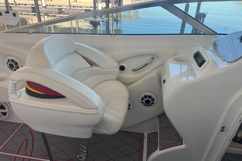 Slide: The Image of 2005 Baja 342 boat interior with white leather seating and control panel. - 14