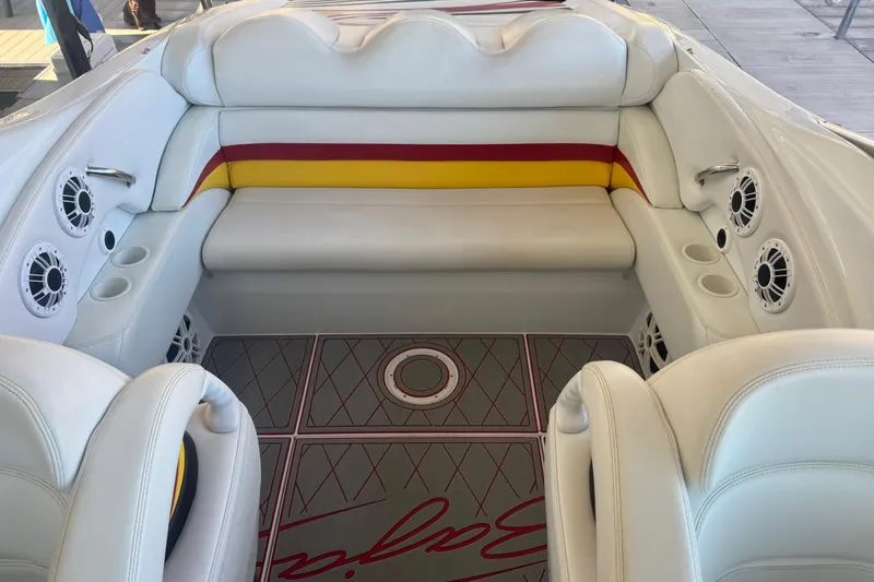 Slide: The Image of Interior of a 2005 Baja 342 boat with white seating and colorful accents. - 15
