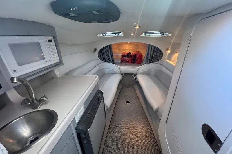 Slide: The Image of Luxurious interior of a 2005 Baja 342 boat with seating, kitchenette, and modern amenities. - 19