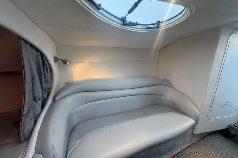 Slide: The Image of Interior of a 2005 Baja 342 boat with plush seating and a skylight. - 23