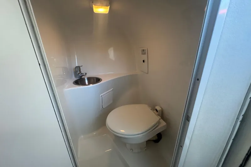 Slide: The Image of Compact bathroom in 2005 Baja 342 boat with toilet and sink. - 24