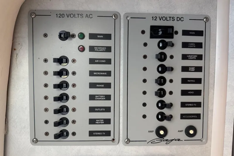 Slide: The Image of Electrical control panel of a 2005 Baja 342 boat with AC and DC switches. - 26