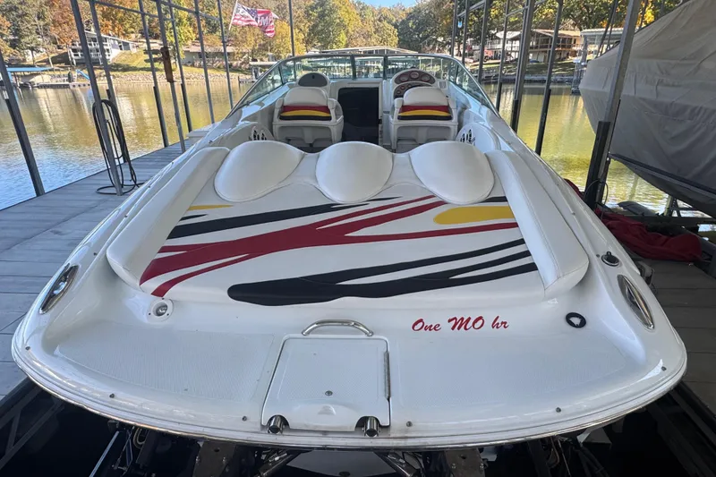 Slide: The Image of 2005 Baja 342 speedboat docked, featuring colorful deck design and comfortable seating. - 3