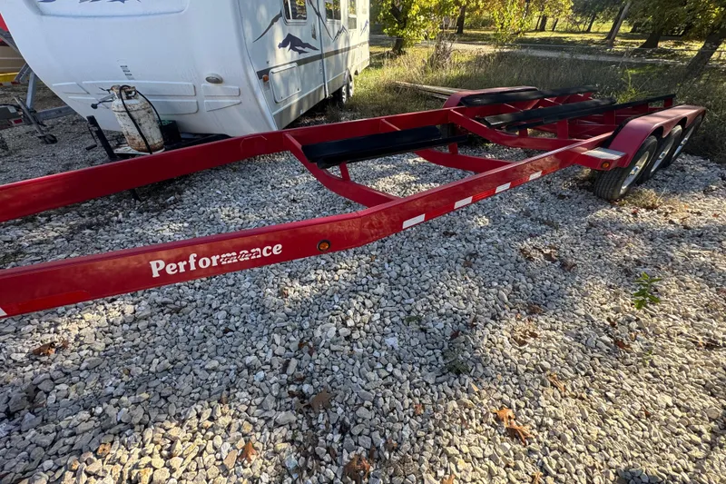 Slide: The Image of Red boat trailer on gravel, near a parked RV, labeled "Performance." - 38
