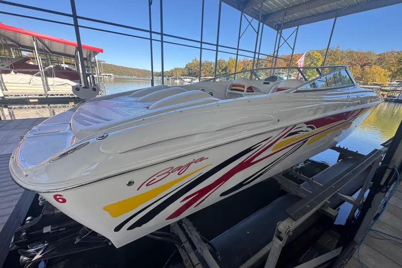 Slide: The Image of 2005 Baja 342 speedboat with vibrant graphics docked at a marina. - 4