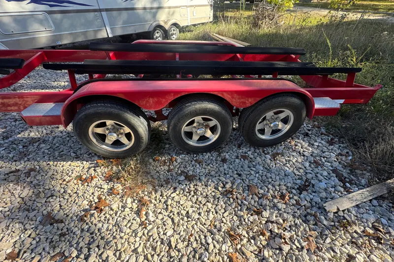 Slide: The Image of Red triple-axle trailer for 2005 Baja 342 boat on gravel surface. - 40