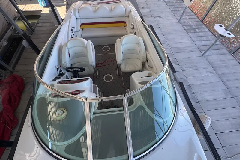 Slide: The Image of 2005 Baja 342 boat with white interior and seating, docked on a wooden platform. - 7
