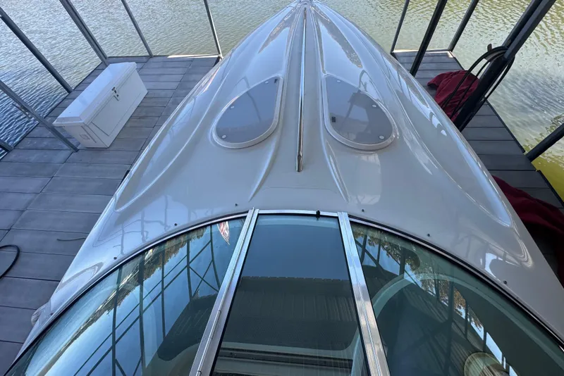 Slide: The Image of 2005 Baja 342 boat docked, top view showing sleek design and water reflection. - 8