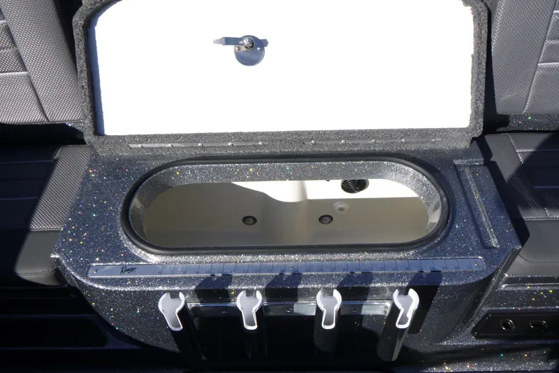 Slide: The Image of Open storage compartment in 2026 Ranger 2080MS boat, featuring sleek design and rod holders. - 15