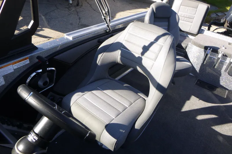 Slide: The Image of 2026 Ranger 2080MS boat interior with gray seating and steering wheel. - 24