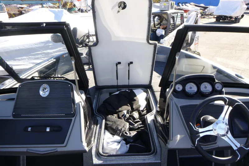 Slide: The Image of Interior view of a 2026 Ranger 2080MS boat, featuring dashboard and storage compartment. - 31