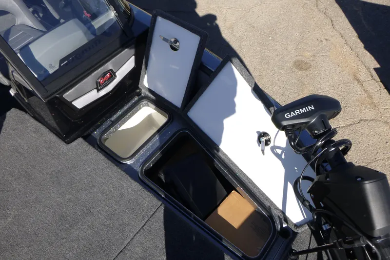 Slide: The Image of 2026 Ranger 2080MS boat interior with Garmin equipment and storage compartments open. - 37