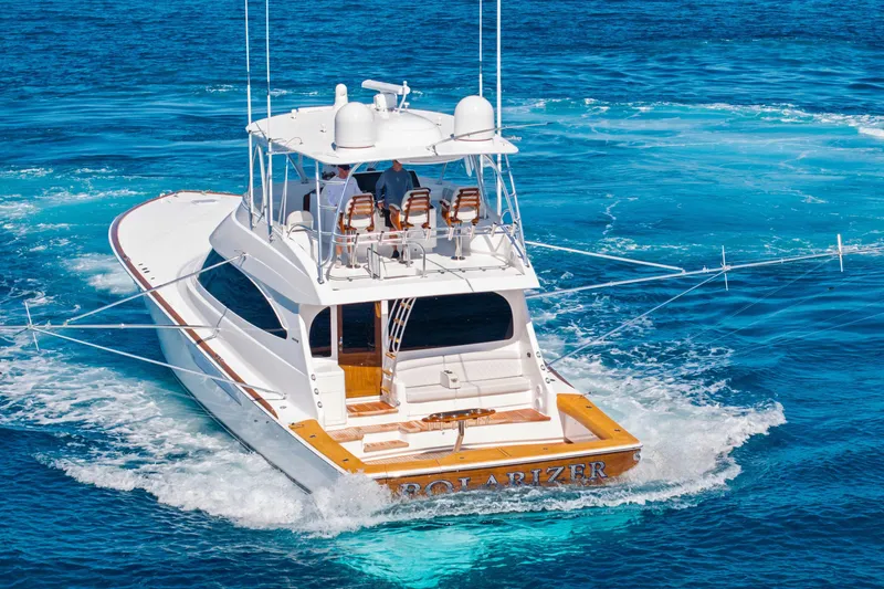 Slide: The Image of 2025 Viking 64 Convertible yacht cruising on clear blue ocean waters. - 10