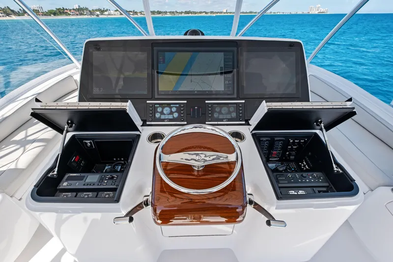 Slide: The Image of 2025 Viking 64 Convertible yacht helm with advanced navigation displays and controls. - 14