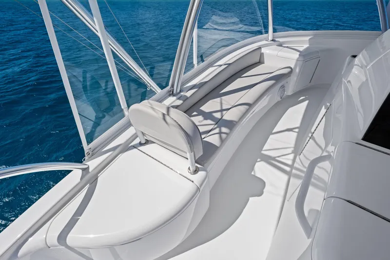 Slide: The Image of 2025 Viking 64 Convertible yacht deck with sleek white seating and ocean view. - 18