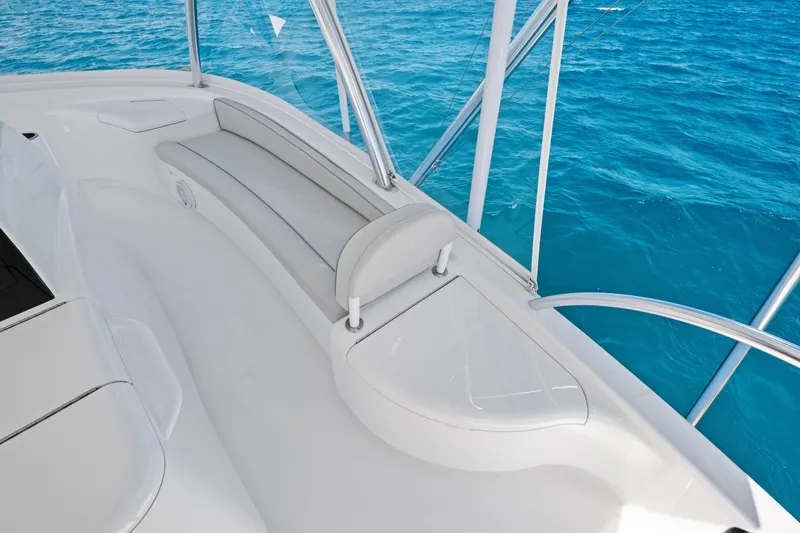 Slide: The Image of 2025 Viking 64 Convertible yacht deck with sleek seating and ocean view. - 19